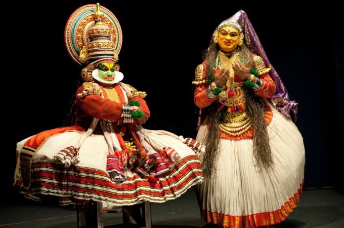 Classical Kathakali performer from Kerala wearing Pacha green makeup and traditional headgear